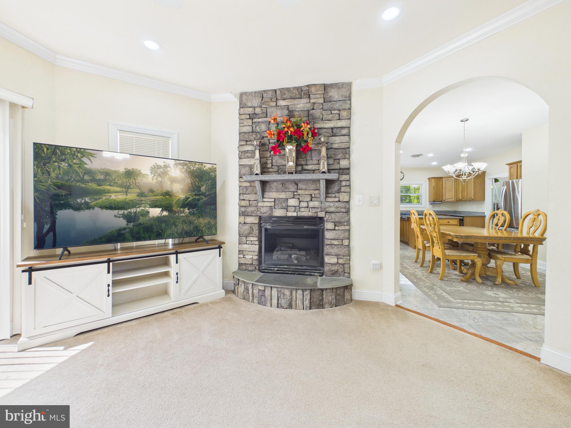 7801 Ridgewood Drive Annandale, VA 22003 - Photo 21 of 72 a living room with furniture a flat screen tv and a fireplace