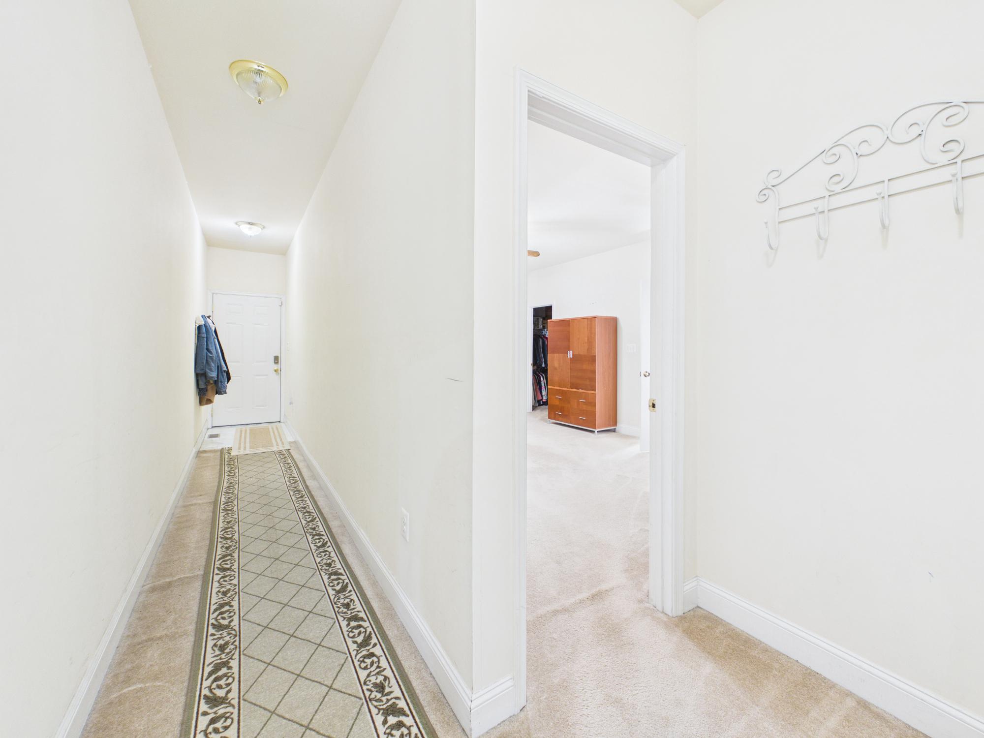 7801 Ridgewood Drive Annandale, VA 22003 - Photo 25 of 72 a view of a hallway with wooden floor and a bathroom