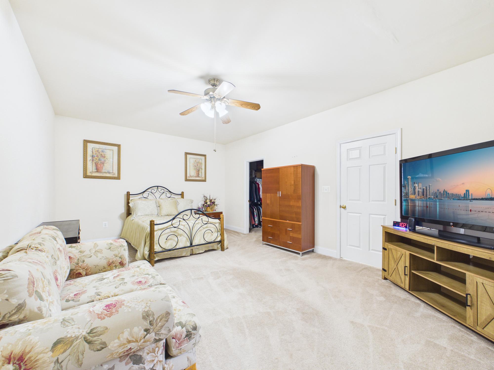 7801 Ridgewood Drive Annandale, VA 22003 - Photo 26 of 72 a bedroom with a bed and a chandelier