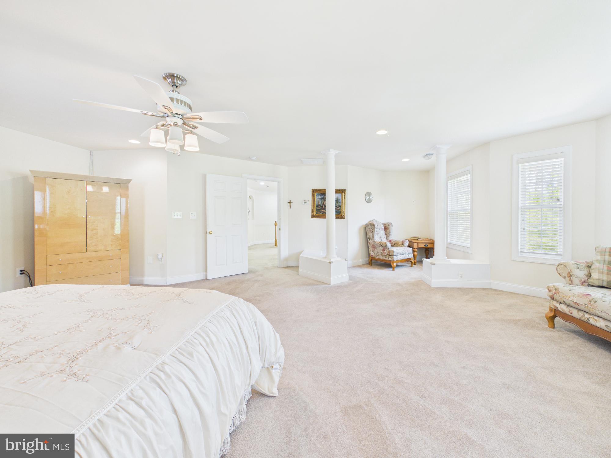 7801 Ridgewood Drive Annandale, VA 22003 - Photo 33 of 72 a spacious bedroom with a large bed and a chandelier