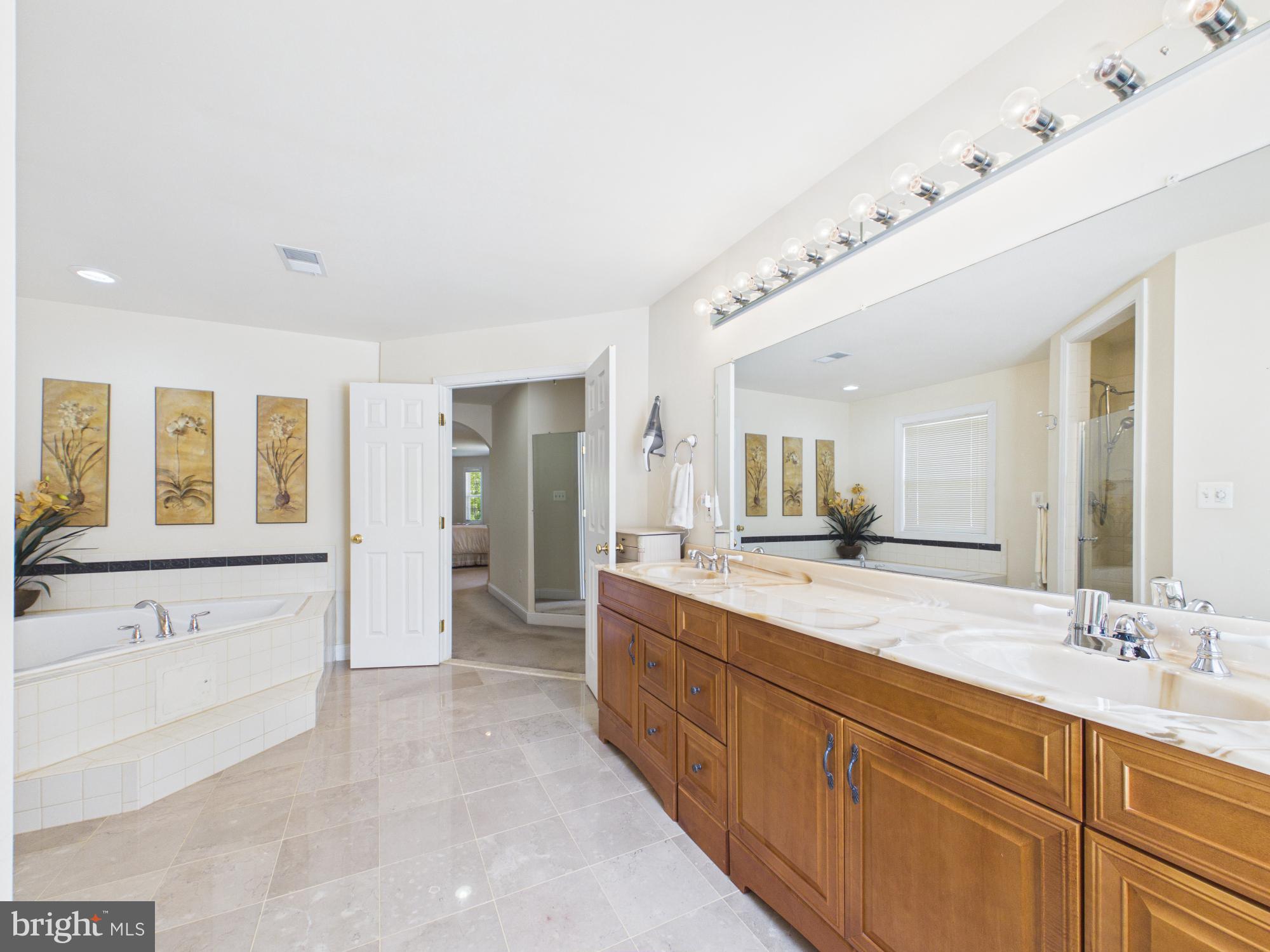 7801 Ridgewood Drive Annandale, VA 22003 - Photo 37 of 72 a spacious bathroom with a granite countertop sink mirror and