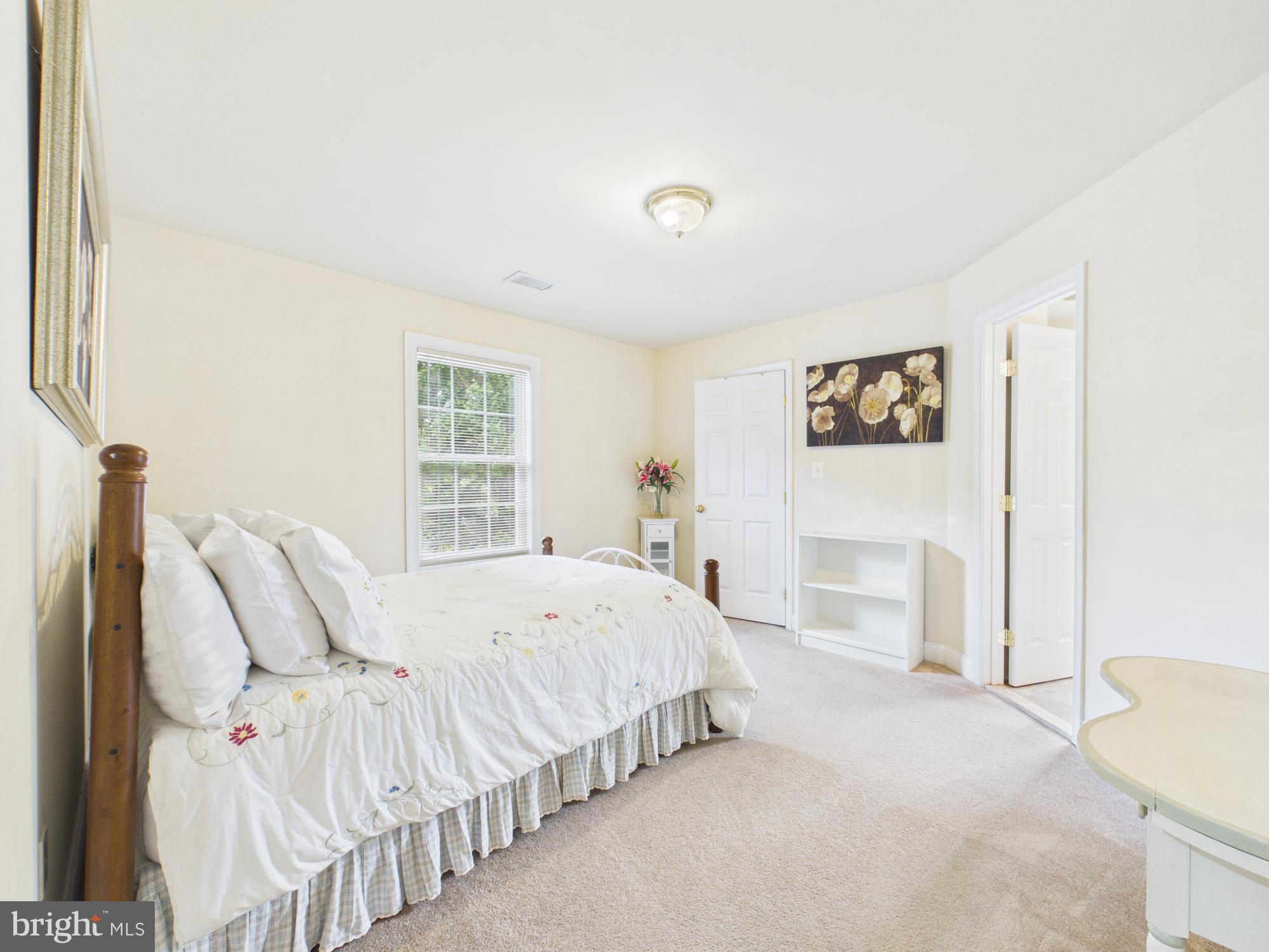 7801 Ridgewood Drive Annandale, VA 22003 - Photo 41 of 72 a spacious bedroom with a bed and a window