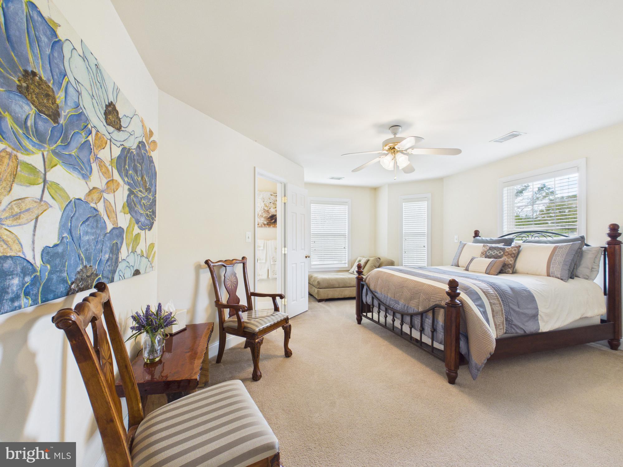 7801 Ridgewood Drive Annandale, VA 22003 - Photo 43 of 72 a spacious bedroom with a bed and a chandelier