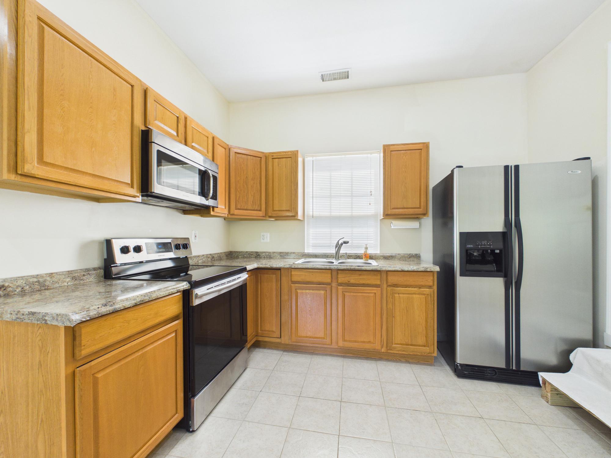 7801 Ridgewood Drive Annandale, VA 22003 - Photo 45 of 72 a kitchen with stainless steel appliances granite countertop a sink stove and refrigerator