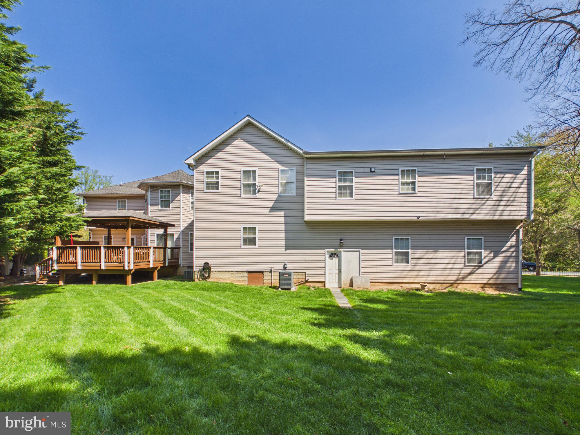7801 Ridgewood Drive Annandale, VA 22003 - Photo 59 of 72 a view of a house with a big yard and potted plants