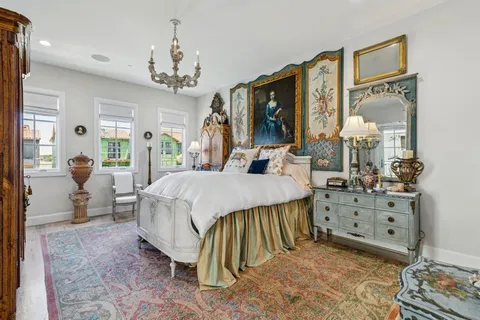 a living room with furniture a flat screen tv and a chandelier