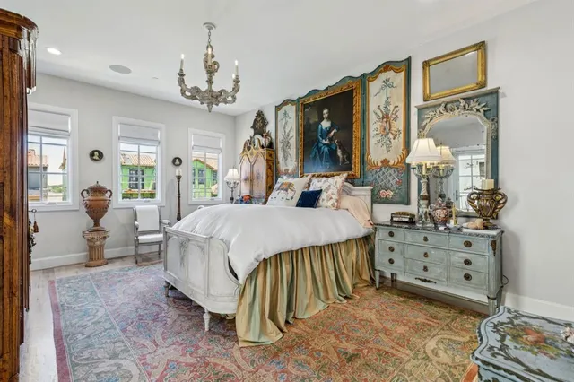 a living room with furniture a flat screen tv and a chandelier