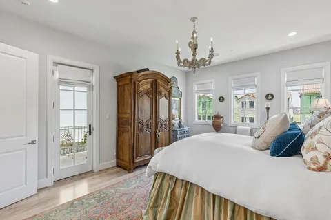 a bed room with a bed and a chandelier