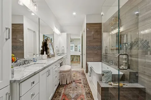 a bathroom with a double vanity sink a mirror and a shower