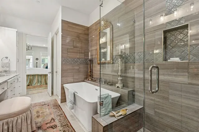 a bathroom with a granite countertop sink a toilet a mirror and shower