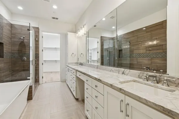 a bathroom with a sink double vanity and shower