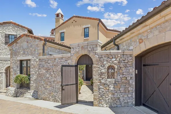a front view of a house with large windows