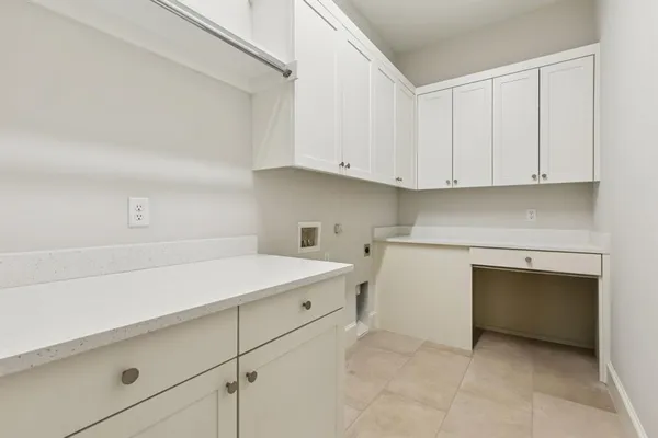 a kitchen with white cabinets and white appliances