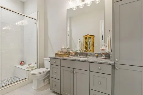 a bedroom with furniture and a large window