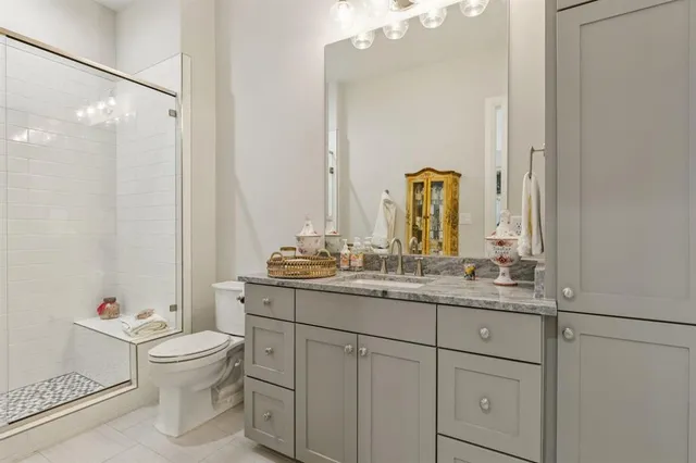 a bedroom with furniture and a large window