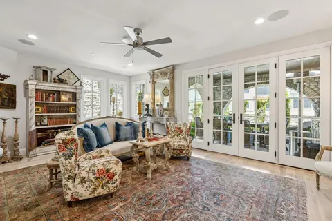 a bathroom with a granite countertop sink a toilet and a mirror