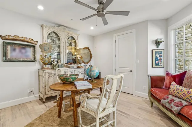 a sink with a granite countertop white cabinets and a sink