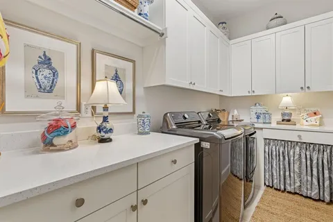 a view of a hallway with wooden floor and stairs