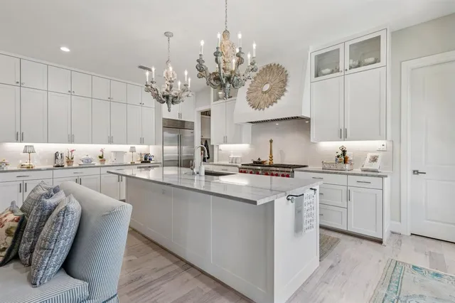 a kitchen with stainless steel appliances granite countertop a white cabinets stove a sink and dishwasher