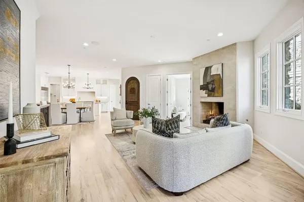 a living room with fireplace furniture and a large window