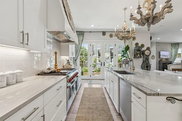 a kitchen with stainless steel appliances a sink stove and cabinets