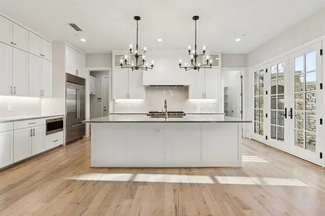 a view of open kitchen with furniture and wooden floor