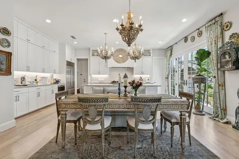 a view of a kitchen island a chandelier and living room view