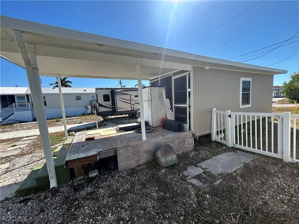 a view of a backyard with furniture and kitchen