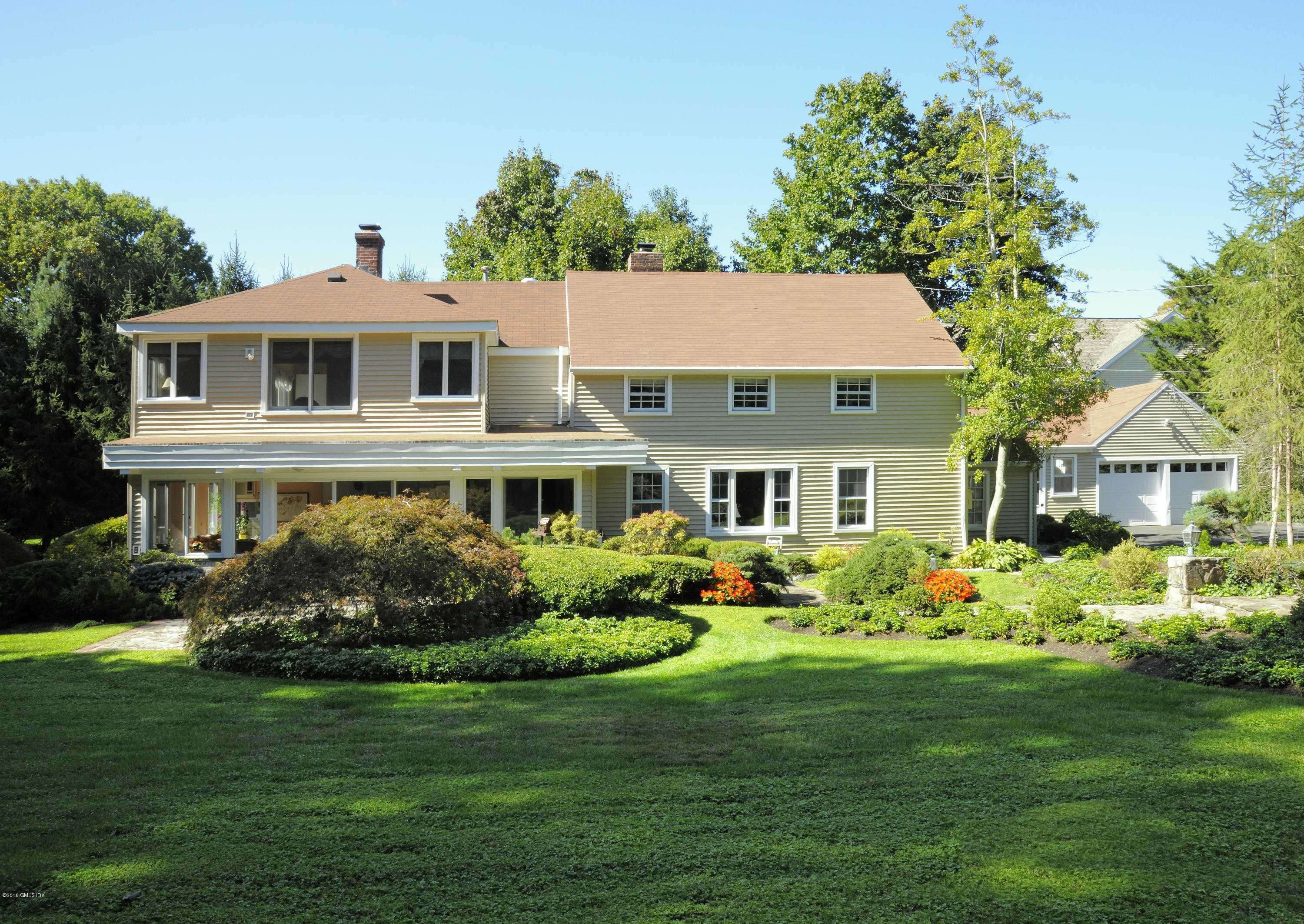 2 Boxwood Lane Greenwich, CT 06830 - Photo 2 of 23 a front view of a house with garden