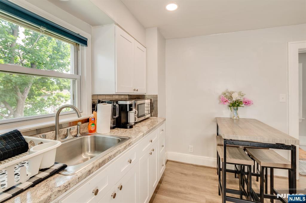 278 High Street Hackensack, NJ 07601 - Photo 4 of 16 a kitchen with stainless steel appliances granite countertop a sink a stove and a refrigerator