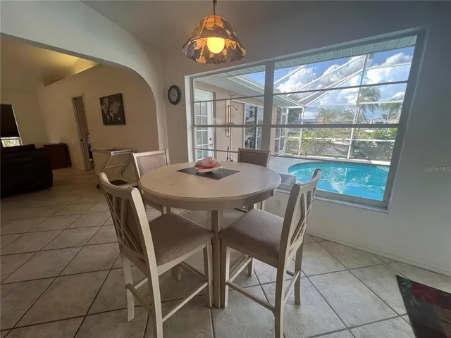 a view of a dining room with furniture window and outside view