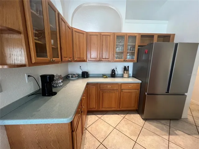 a kitchen with stainless steel appliances granite countertop a refrigerator sink and cabinets