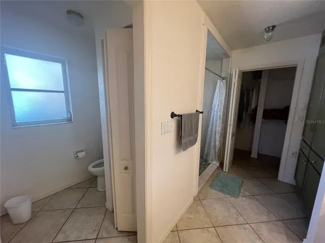 a bathroom with a toilet and a shower