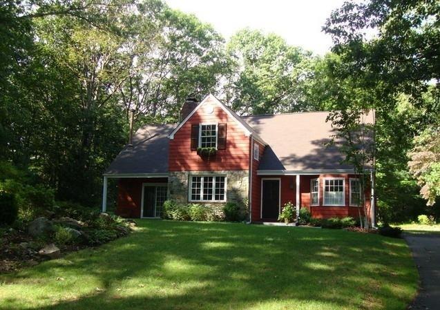 a front view of a house with a garden and porch