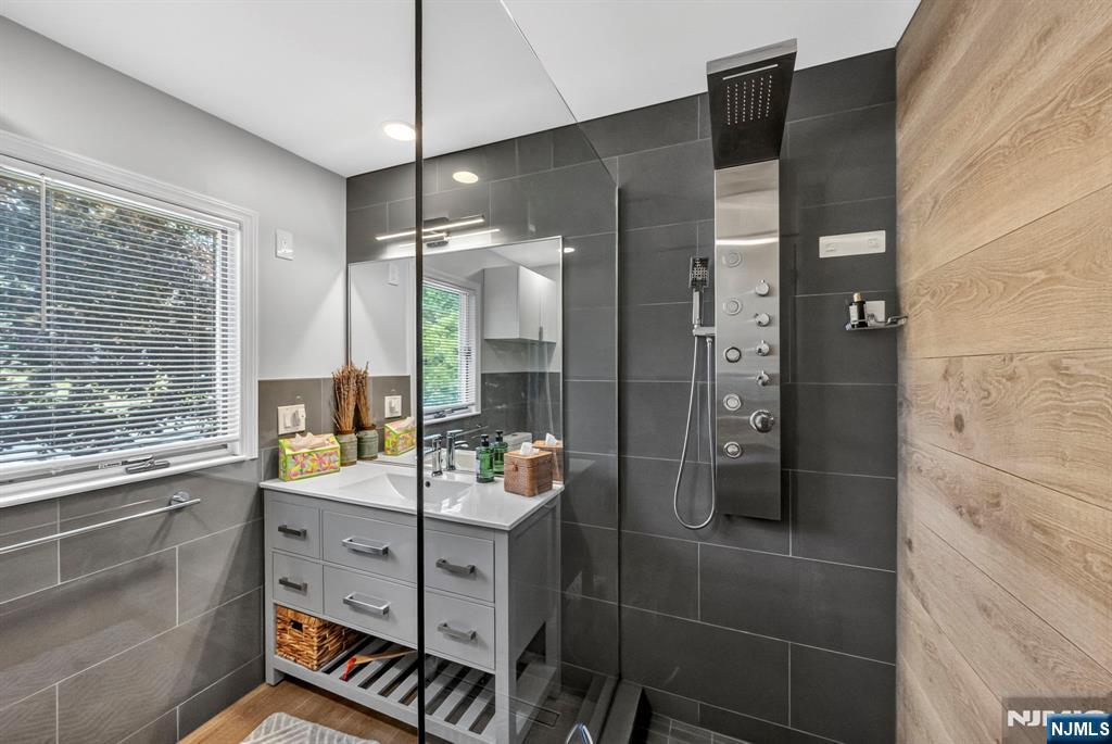57 Hemlock Road Little Falls, NJ 07424 - Photo 21 of 50 a bathroom with a tub shower vanity and sink
