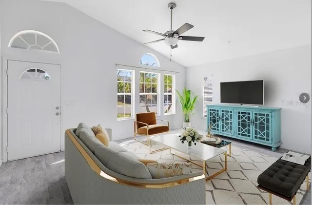 a living room with furniture and a flat screen tv