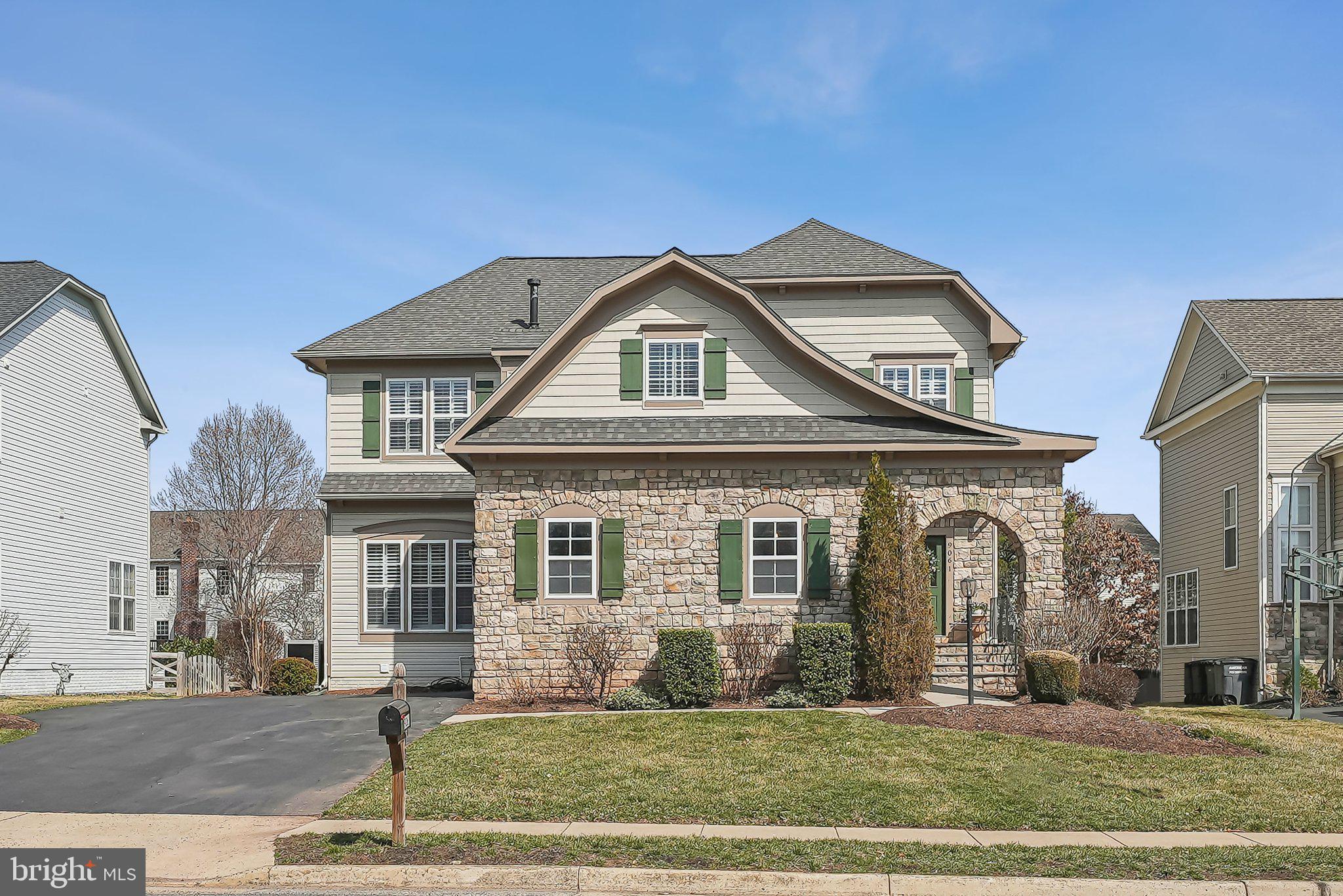 9061 Roaring Spring Loop Bristow, VA 20136 - Photo 1 of 55 a front view of a house with a yard