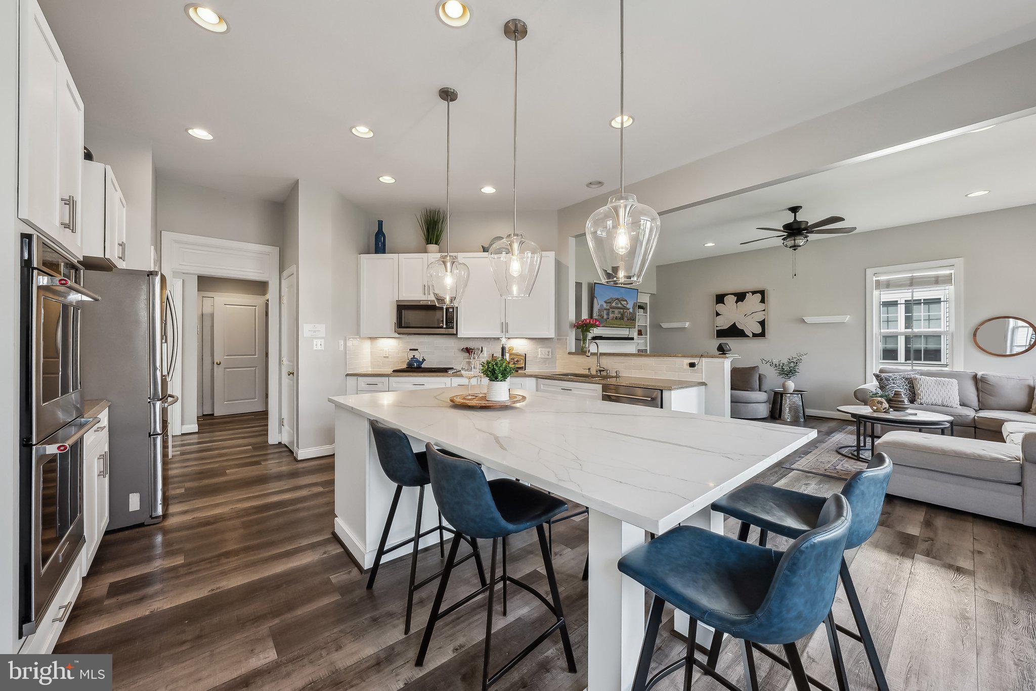 9061 Roaring Spring Loop Bristow, VA 20136 - Photo 11 of 55 a large kitchen with a table and chairs