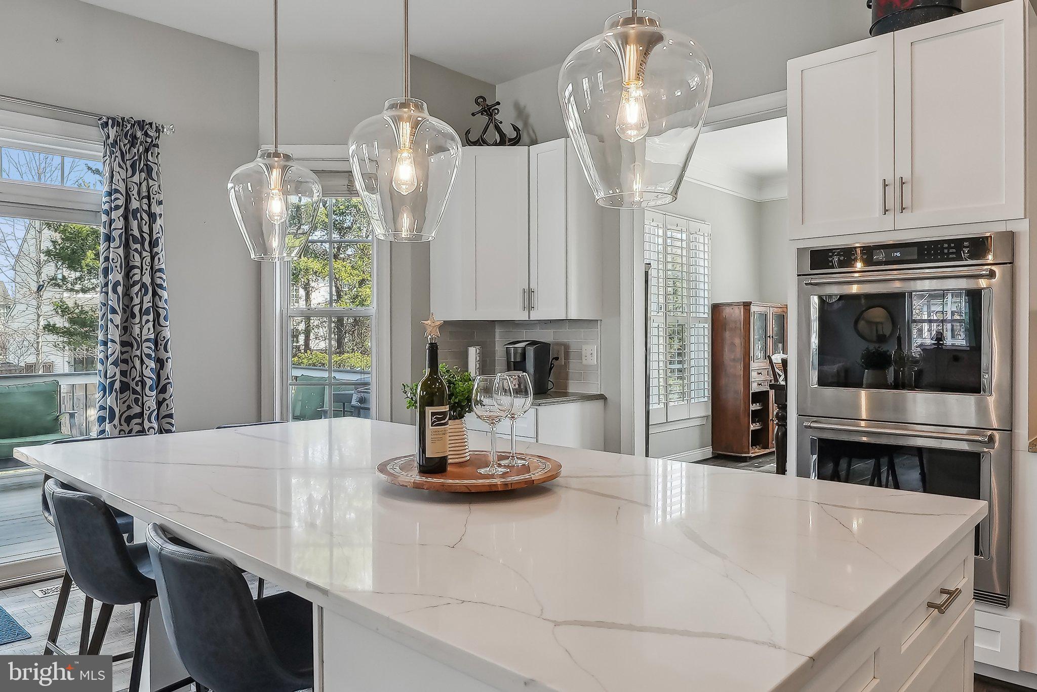 9061 Roaring Spring Loop Bristow, VA 20136 - Photo 13 of 55 a kitchen with a table chairs and microwave