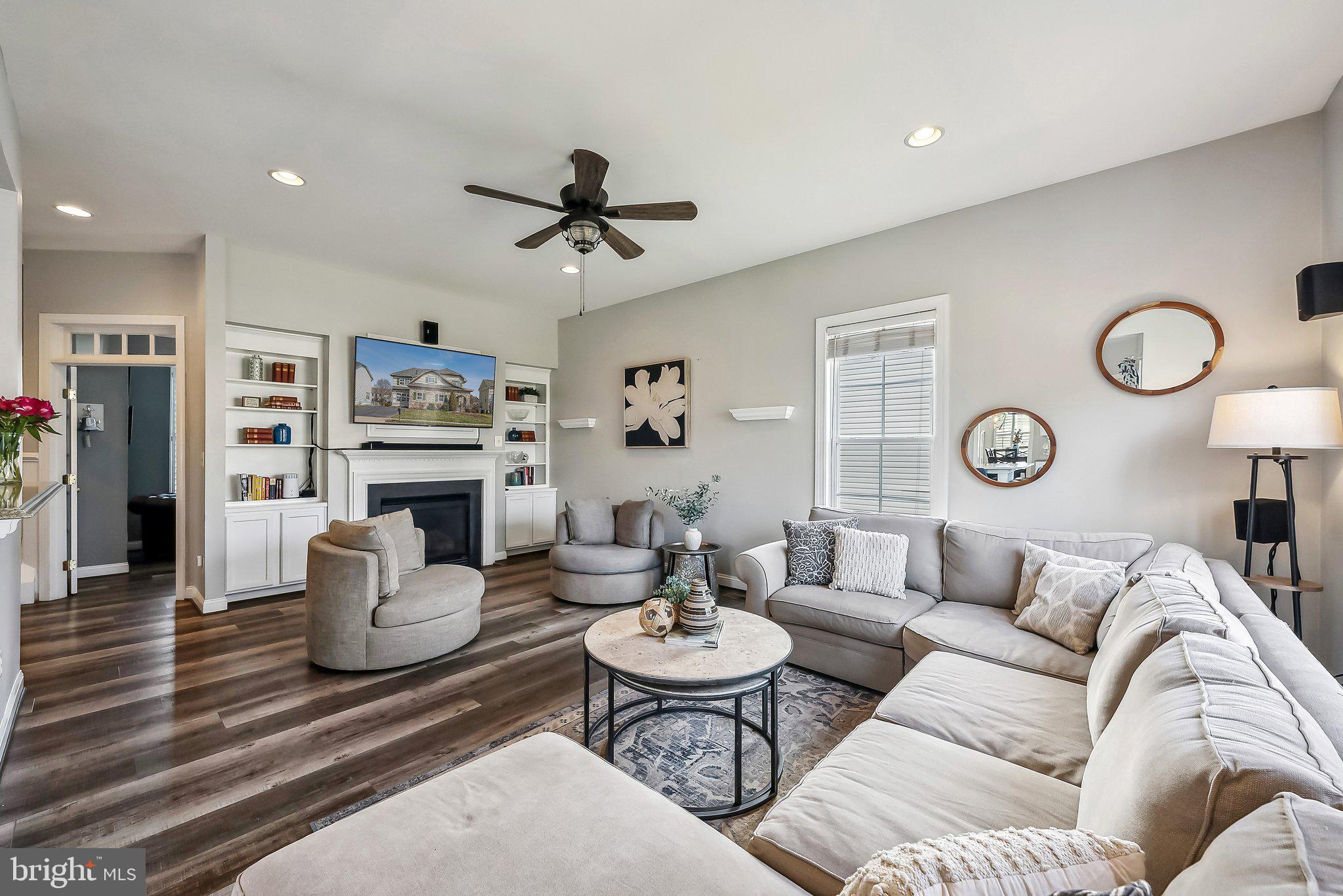 9061 Roaring Spring Loop Bristow, VA 20136 - Photo 16 of 55 a living room with furniture a clock and a rug