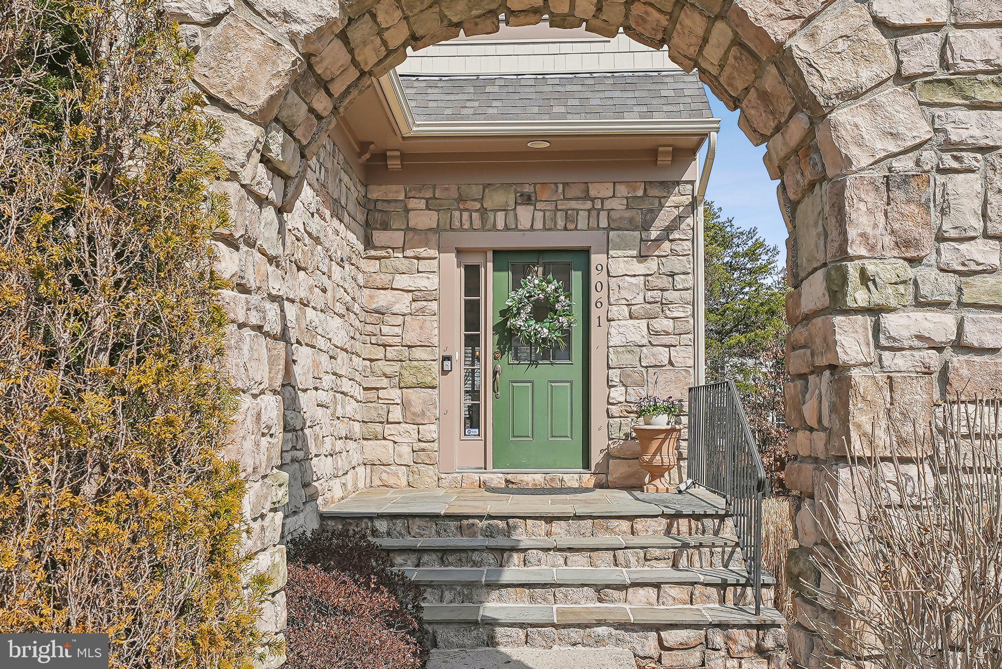 9061 Roaring Spring Loop Bristow, VA 20136 - Photo 2 of 55 a front view of a building with a garden and plants