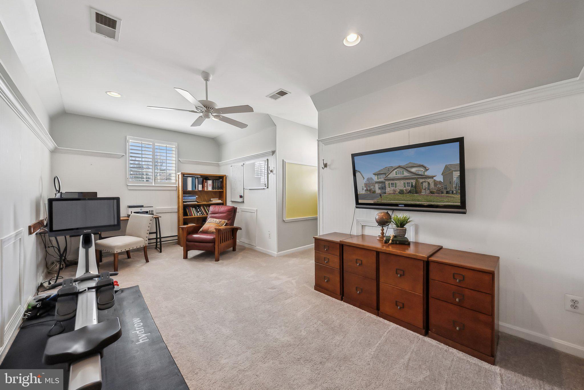 9061 Roaring Spring Loop Bristow, VA 20136 - Photo 28 of 55 a living room with furniture and a flat screen tv