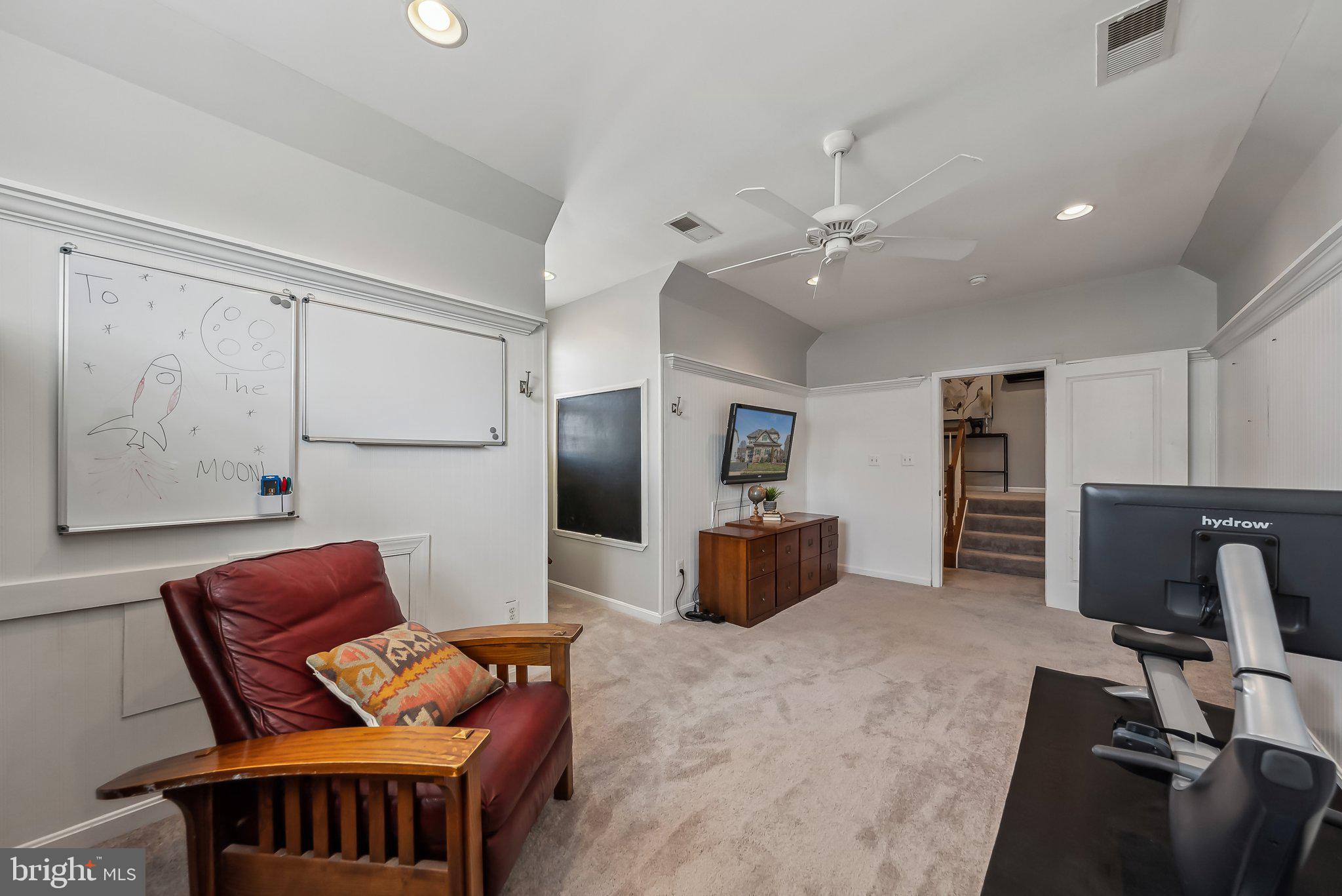 9061 Roaring Spring Loop Bristow, VA 20136 - Photo 29 of 55 a projector room with furniture and a flat screen tv