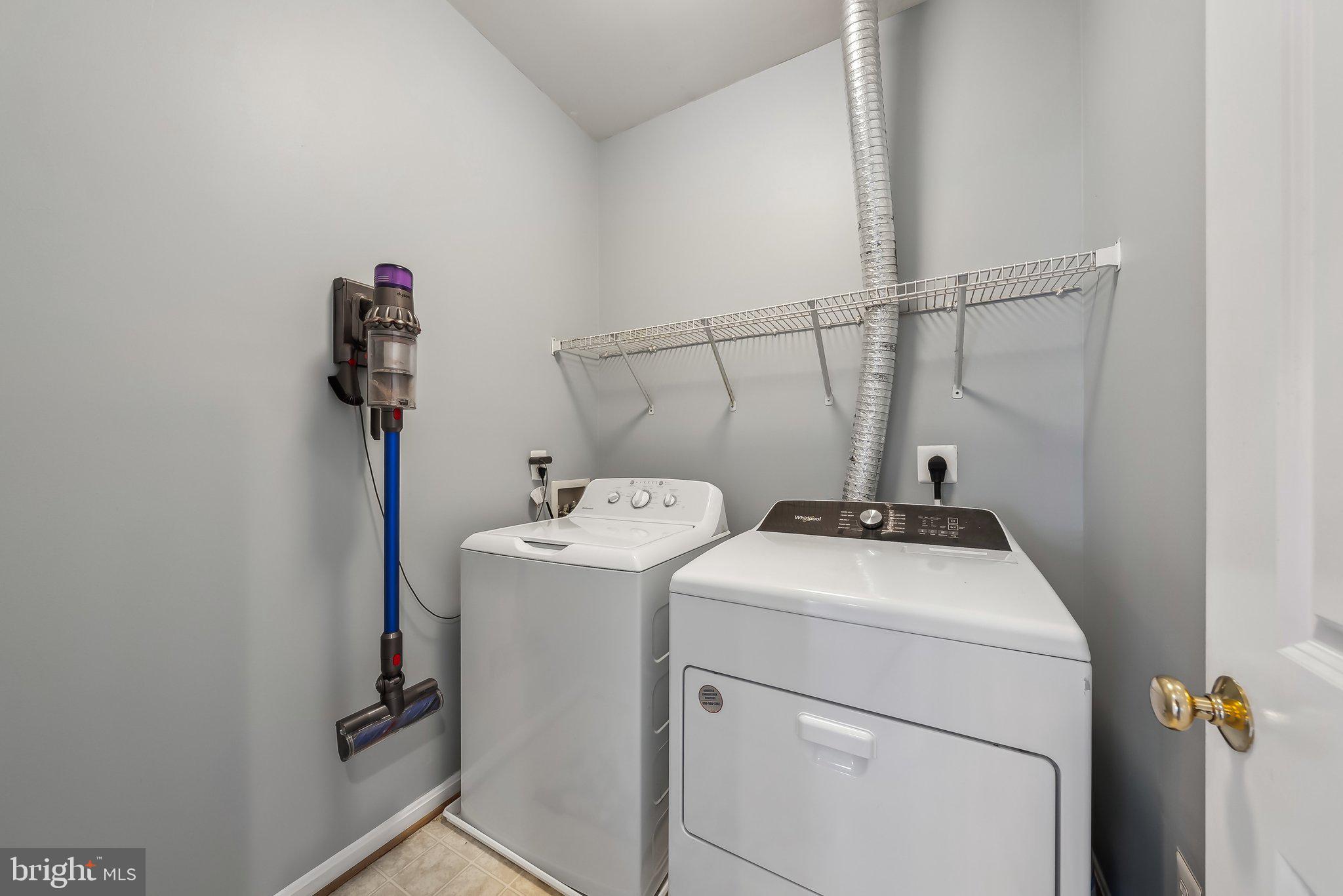 9061 Roaring Spring Loop Bristow, VA 20136 - Photo 30 of 55 a utility room with dryer and washer