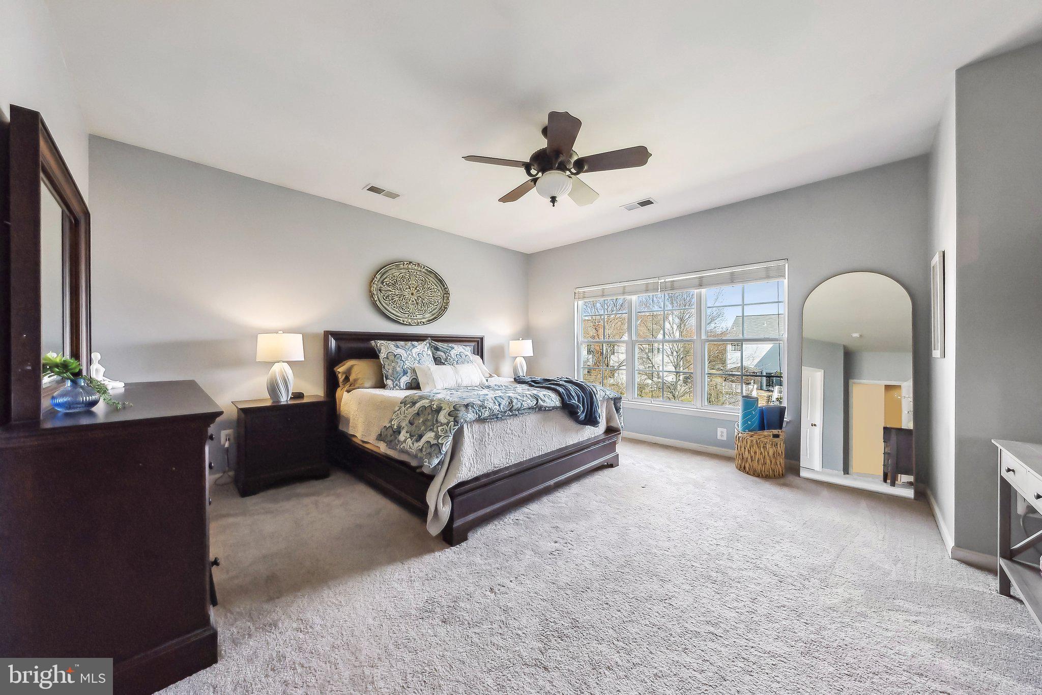 9061 Roaring Spring Loop Bristow, VA 20136 - Photo 31 of 55 a bedroom with a bed couch and window