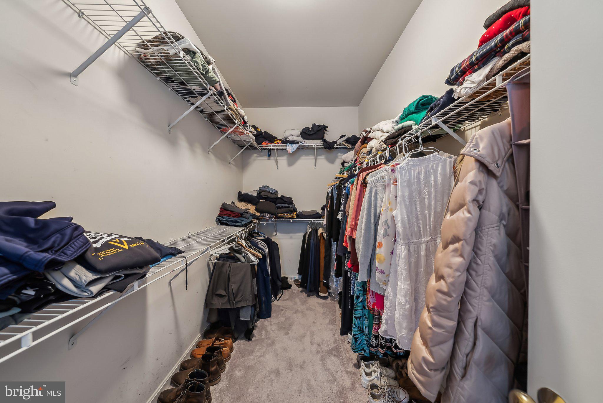 9061 Roaring Spring Loop Bristow, VA 20136 - Photo 34 of 55 a view of walk in closet with clothes and shoes
