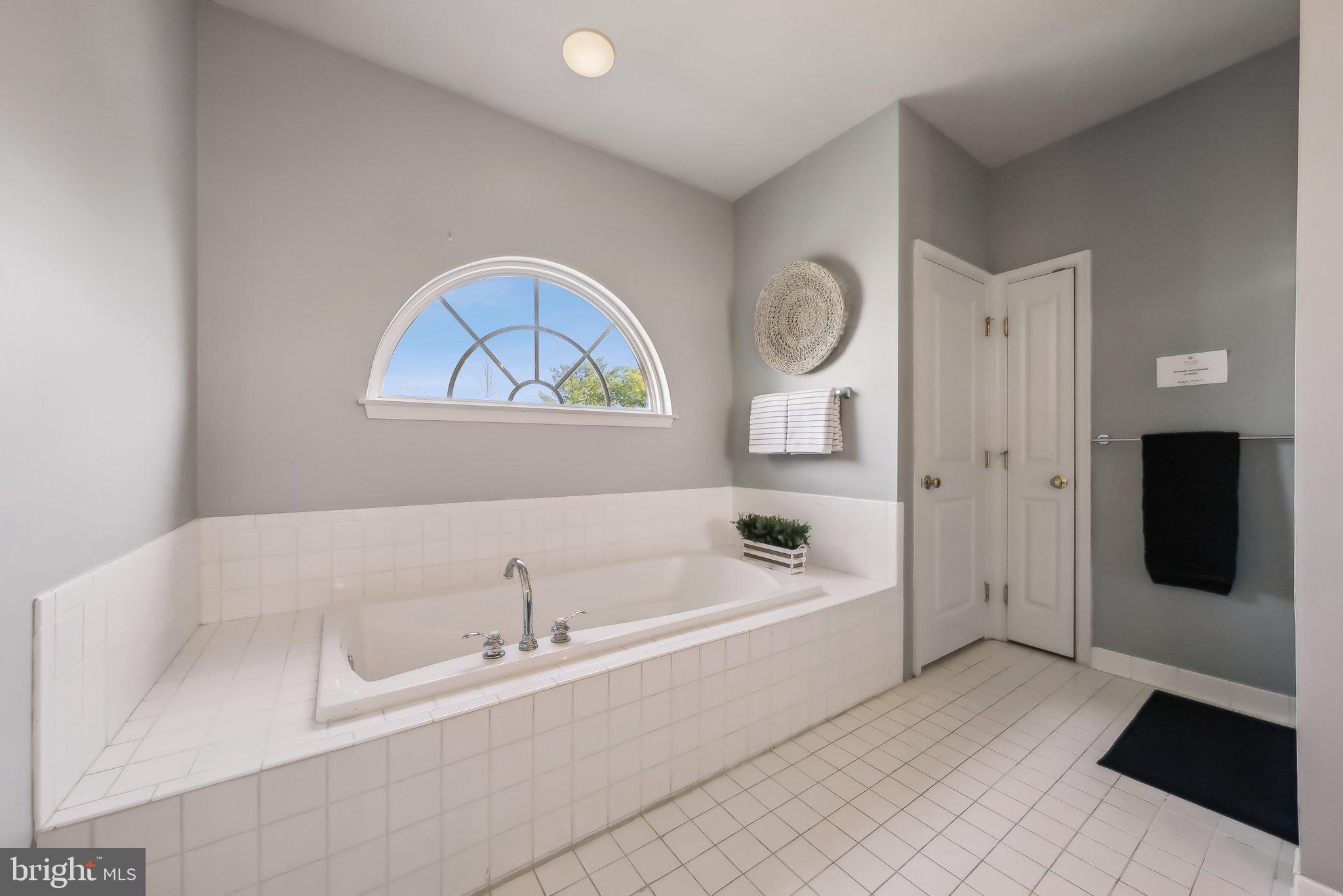9061 Roaring Spring Loop Bristow, VA 20136 - Photo 36 of 55 a bathroom with a bathtub and a shower