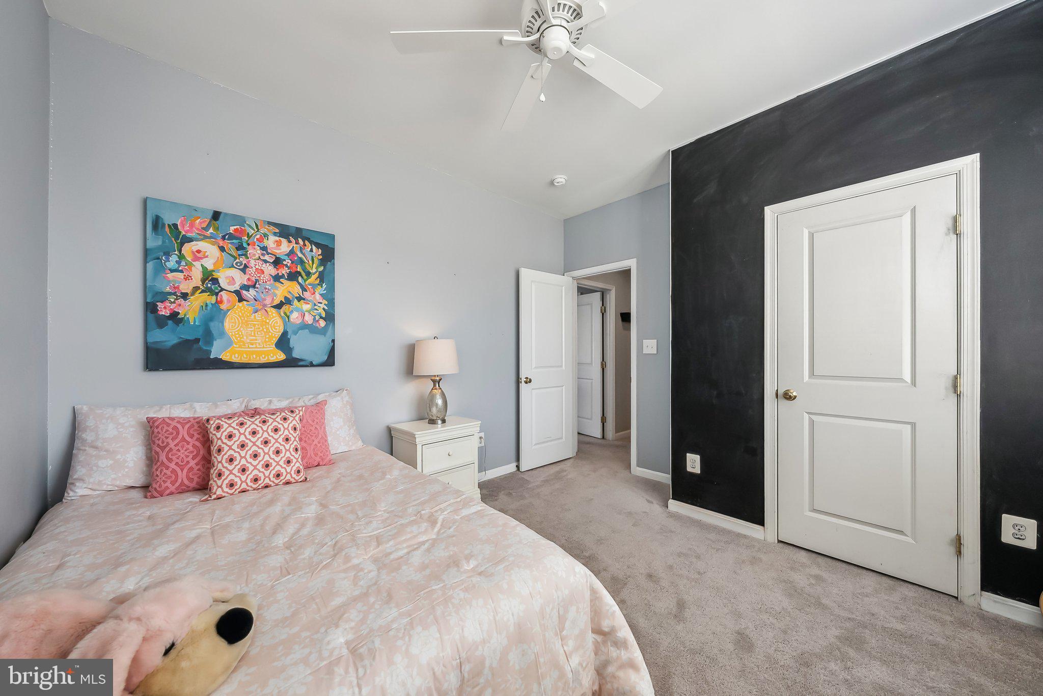 9061 Roaring Spring Loop Bristow, VA 20136 - Photo 40 of 55 a bedroom with a large bed and a chandelier