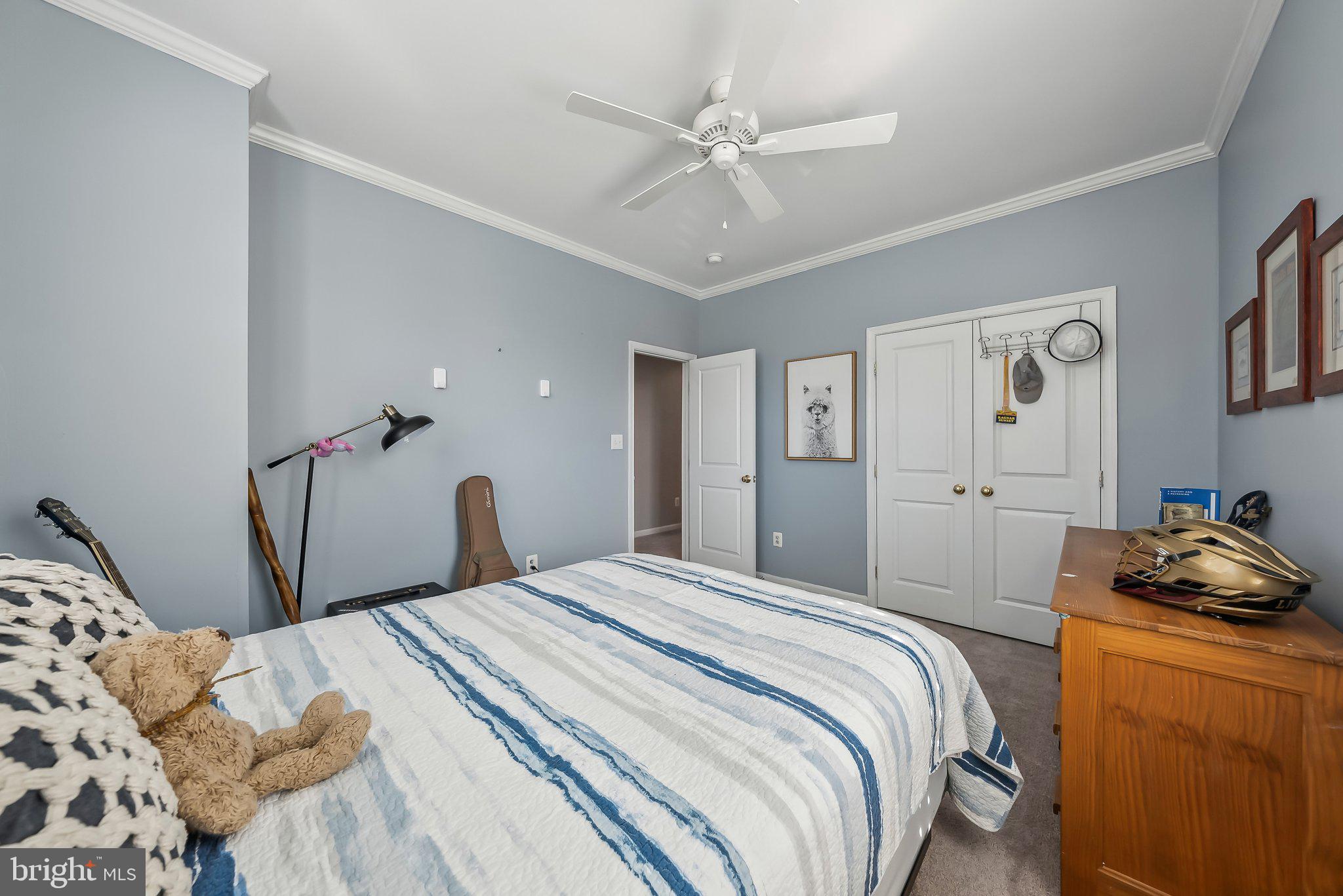 9061 Roaring Spring Loop Bristow, VA 20136 - Photo 42 of 55 a bedroom with a bed and a chandelier