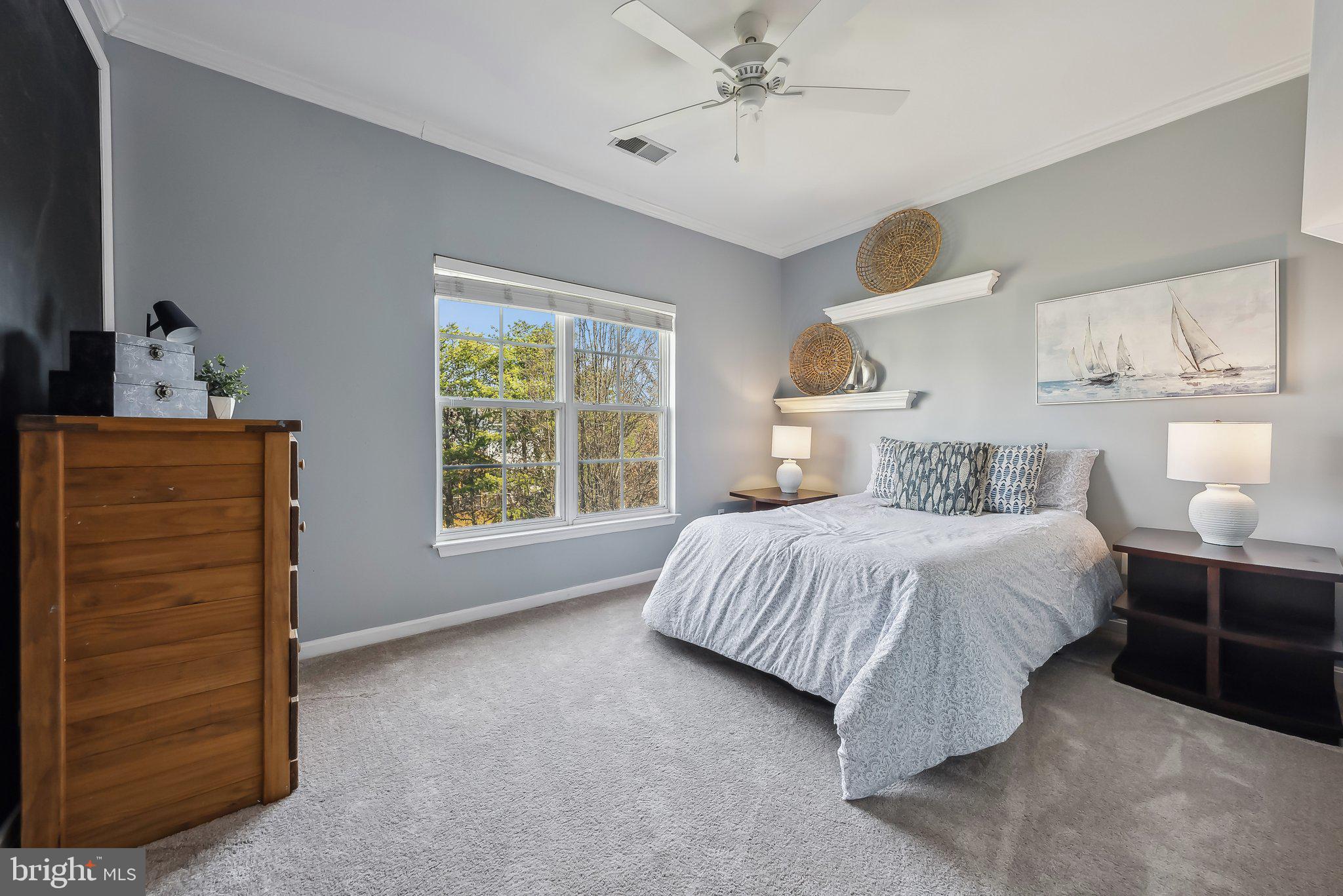 9061 Roaring Spring Loop Bristow, VA 20136 - Photo 44 of 55 a bedroom with a bed and a dresser